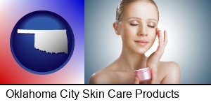 Oklahoma City, Oklahoma - a woman applying skin cream to her face