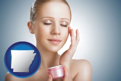 arkansas a woman applying skin cream to her face