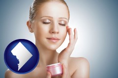 washington-dc a woman applying skin cream to her face