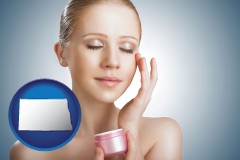 north-dakota map icon and a woman applying skin cream to her face