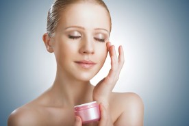 a woman applying skin cream to her face